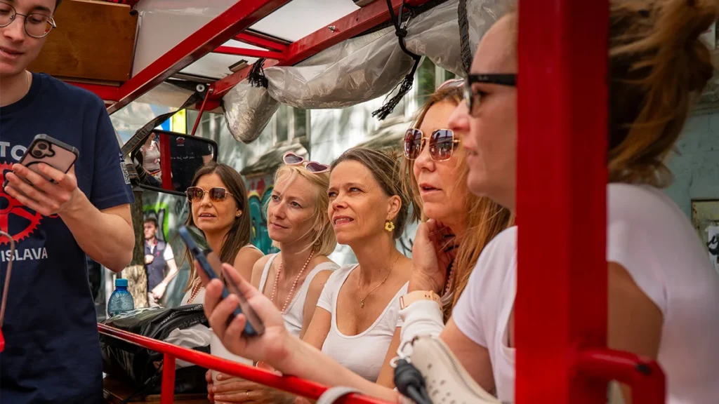 Guests on a Bratislava Bike Tour listening to a guide or quiz on board